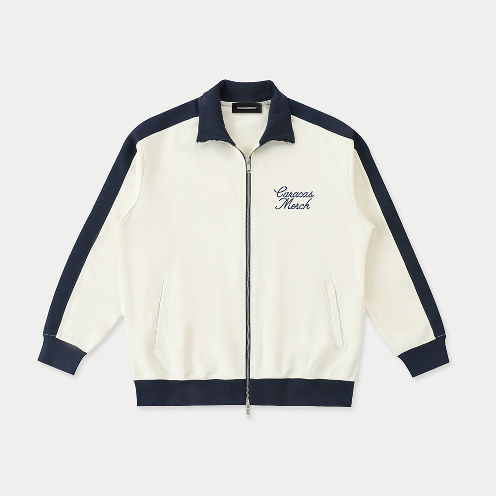 Front view of cream Caracas Merch zip jacket with navy details