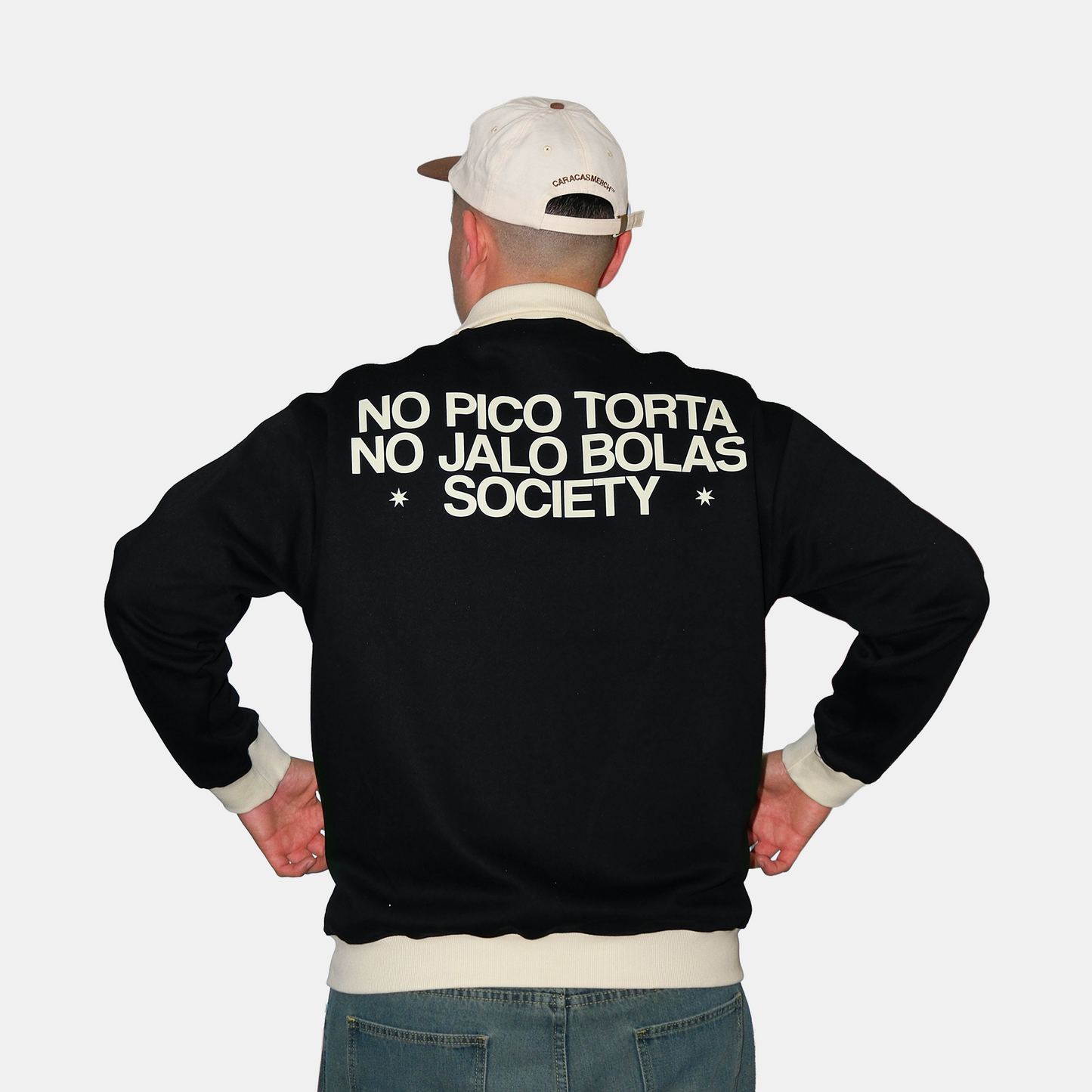 Back view of male model wearing navy Caracas Merch jacket with No Pico Torta No Jalo Bolas Society graphic