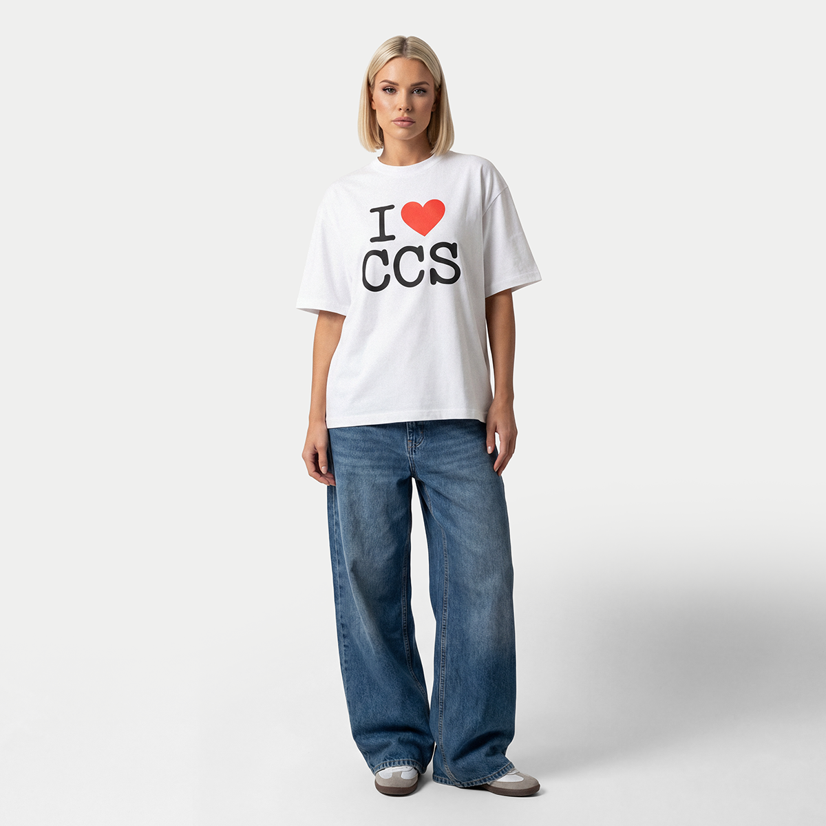 Female model wearing i love caracas white graphic t-shirt by Caracas Merch