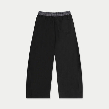 Back view of black tracksuit sweatpants with rear pocket by Caracas Merch