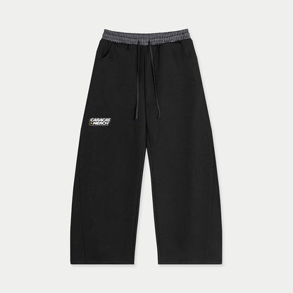 Front view of black sweatpants with Caracas Merch logo
