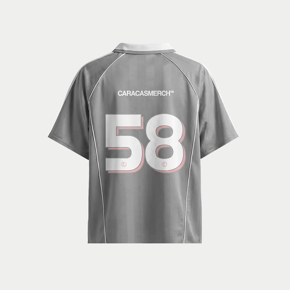 Grey soccer-style jersey back view with “CARACASMERCH” text on upper back and large number 58 in white with red outline – Caracas Merch