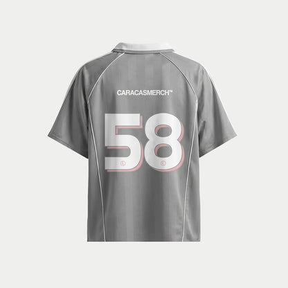 Grey soccer-style jersey back view with “CARACASMERCH” text on upper back and large number 58 in white with red outline – Caracas Merch