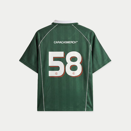 Green soccer-style jersey back view with “CARACASMERCH” text on upper back and large number 58 in white with red outline – Caracas Merch