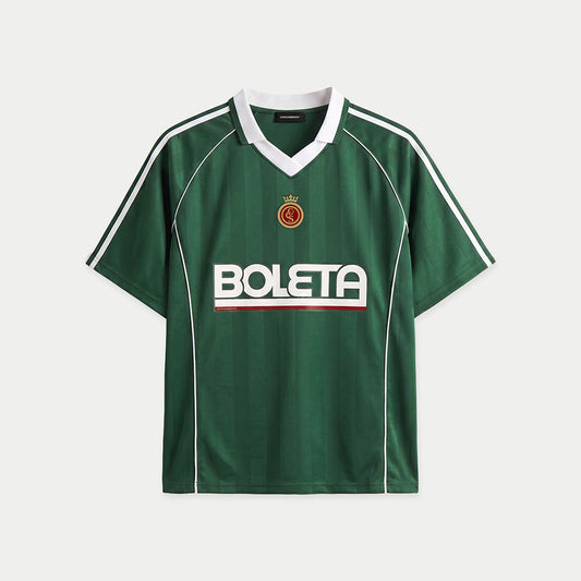Green soccer-style jersey front view with striped texture, V-neck collar, and bold “BOLETA” graphic across the chest – Caracas Merch