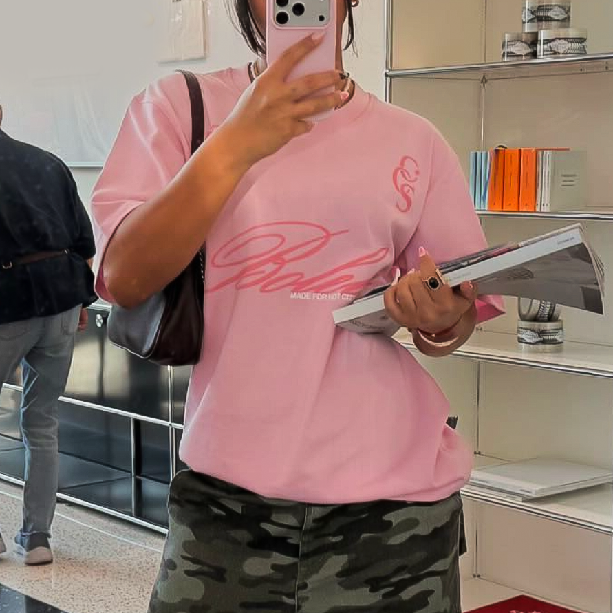 Model wearing pink Boleta oversized graphic t-shirt in casual streetwear look