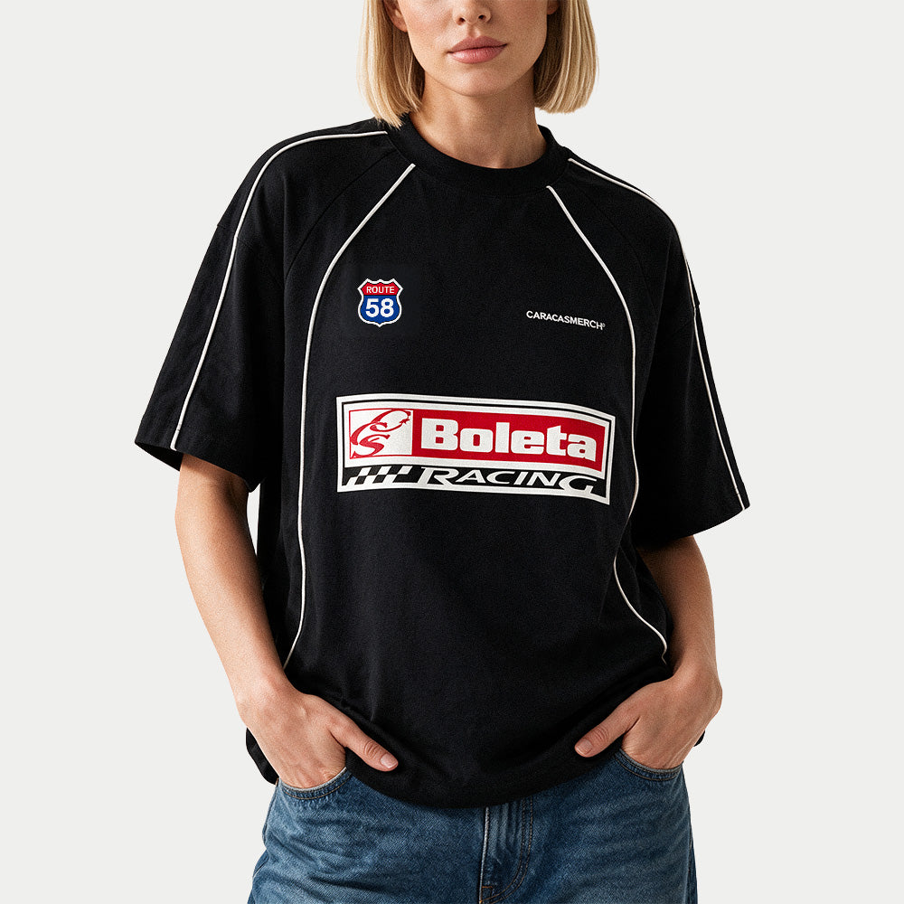 Female model wearing the black Boleta Racing jersey by Caracas Merch, front view