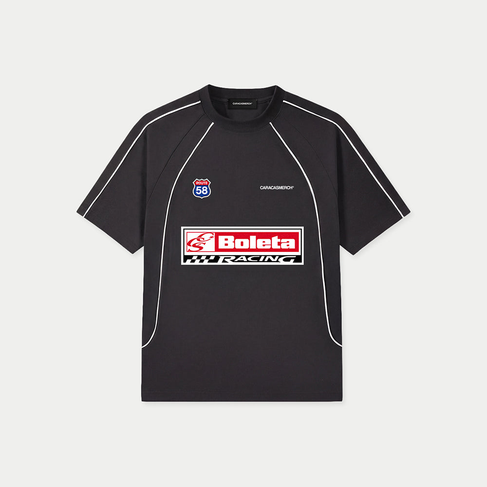 Black Boleta Racing jersey by Caracas Merch with “Boleta Racing” patch graphic at front, front view