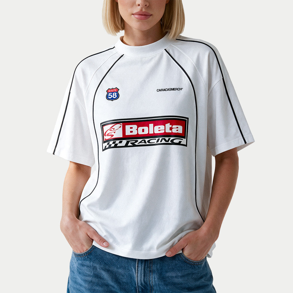 Female model wearing the white Boleta Racing jersey by Caracas Merch, front view