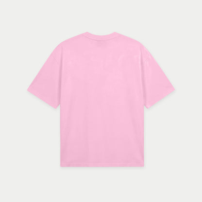Pink oversized t-shirt back view with eraser graphic and “Bórralo que fue con lápiz” text in blue label style – Caracas Merch