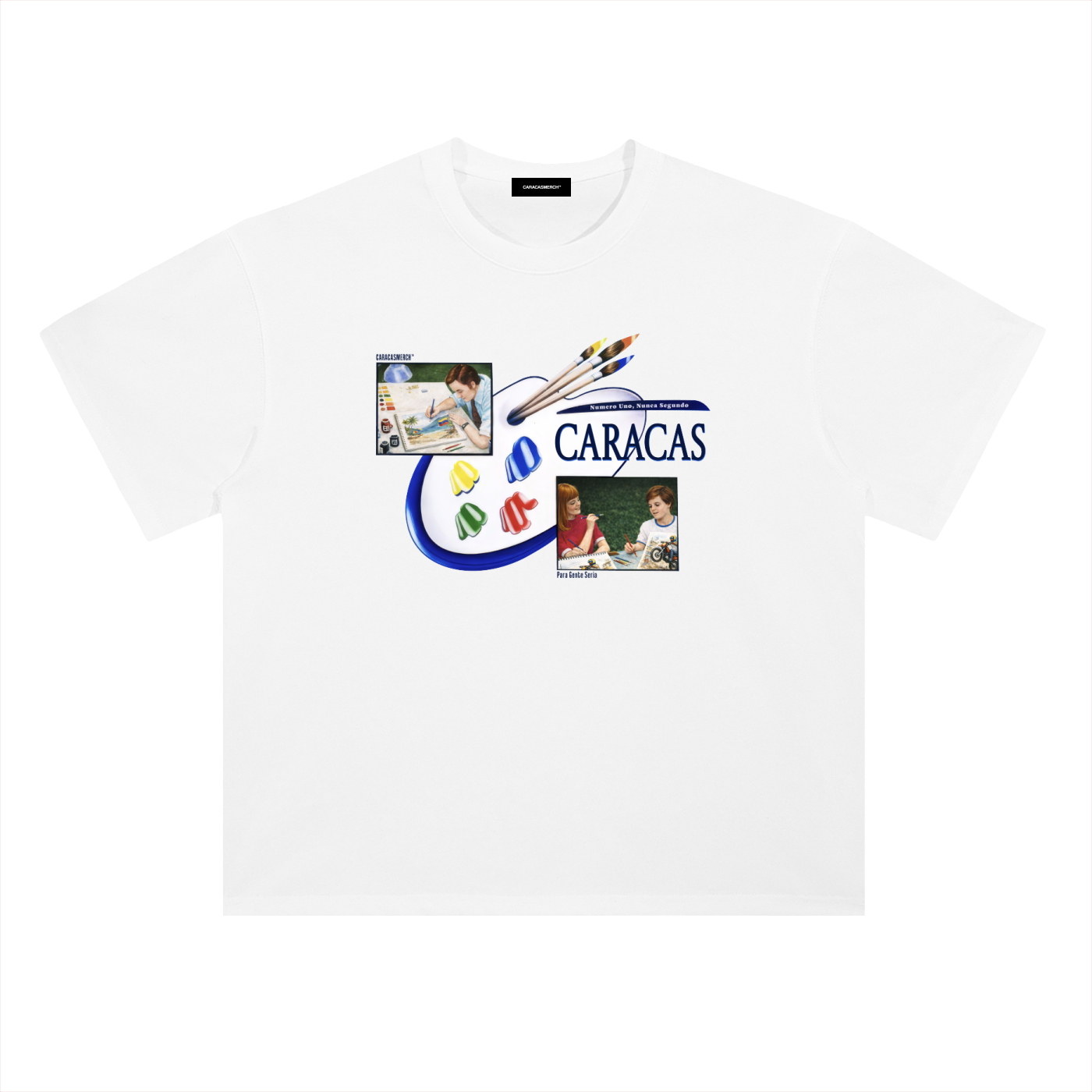 White oversized t-shirt front view with collage-style graphic featuring paint palette, brushes, and vintage classroom images with “Caracas” text – Caracas Merch