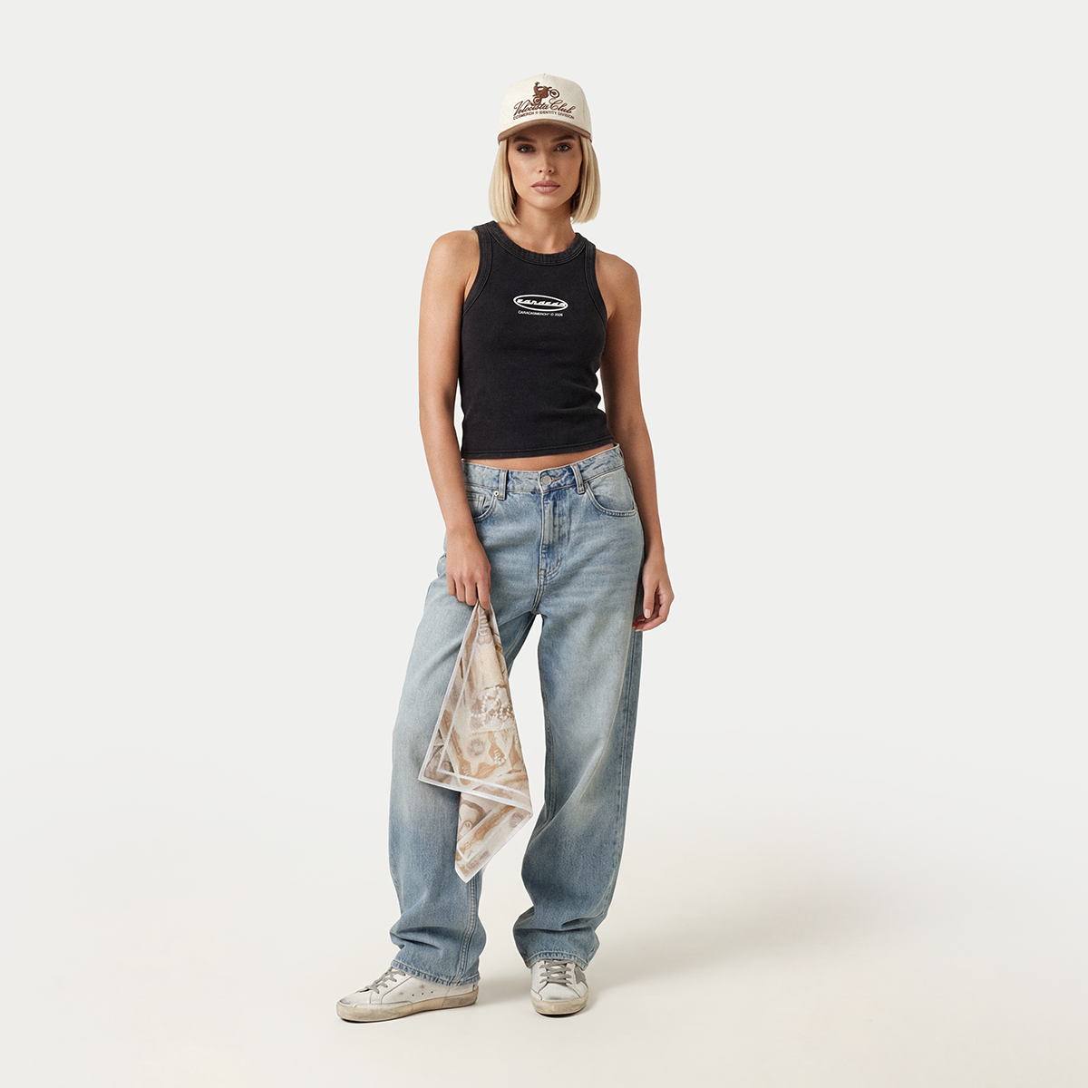 Model wearing black Caracas graphic tank top styled with baggy jeans
