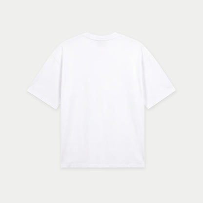White oversized t-shirt back view with collage-style graphic featuring paint palette, brushes, and vintage classroom images with “Caracas” text – Caracas Merch
