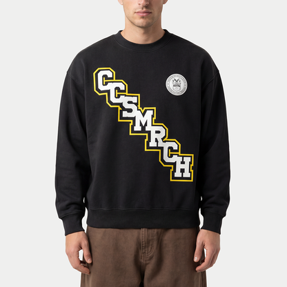 Model wearing dark Caracas Merch CCSMRCH varsity crewneck sweatshirt