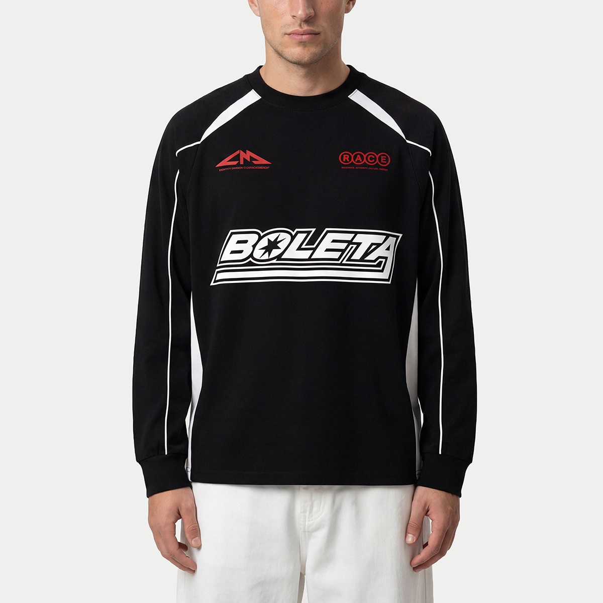 Model wearing black Boleta racing long sleeve by Caracas Merch