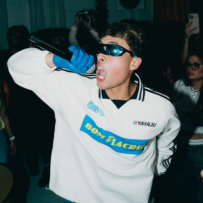 Soucream wearing Bom Lacreo windbreaker during live performance