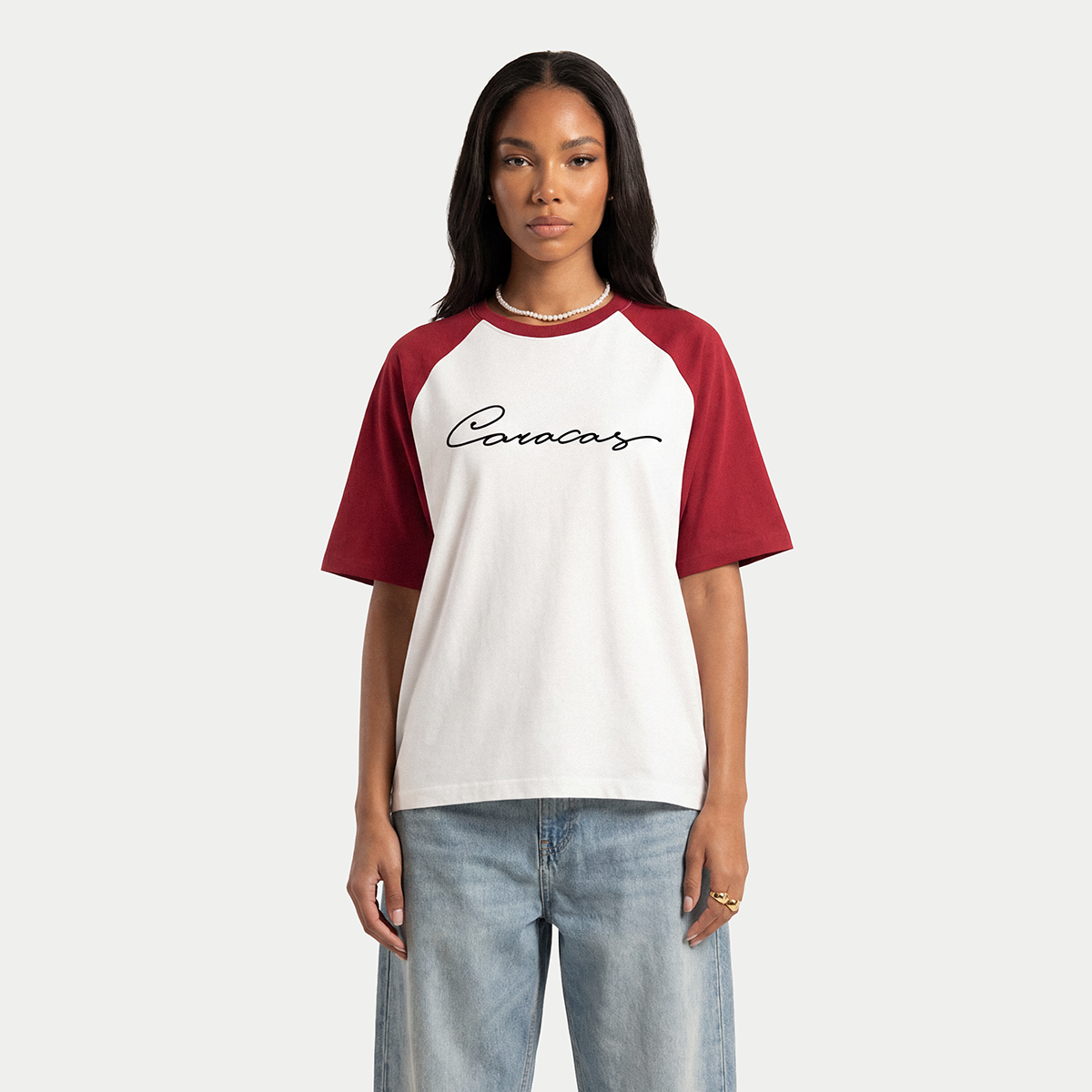 Model wearing white and burgundy Caracas Merch raglan t-shirt
