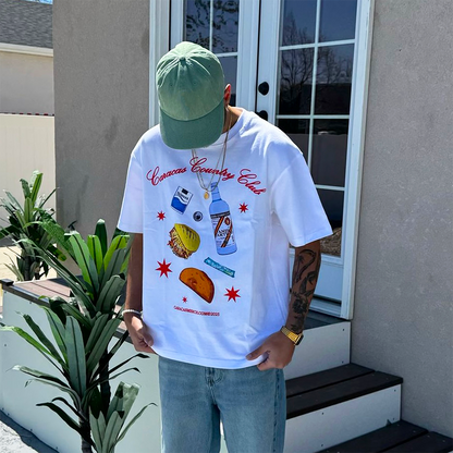 Male model wearing white Caracas Country Club graphic t-shirt outdoors