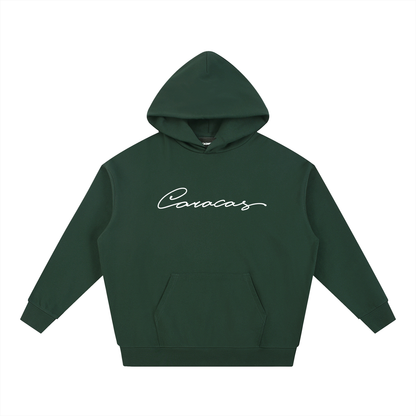 Green Caracas Merch hoodie with white script logo on front
