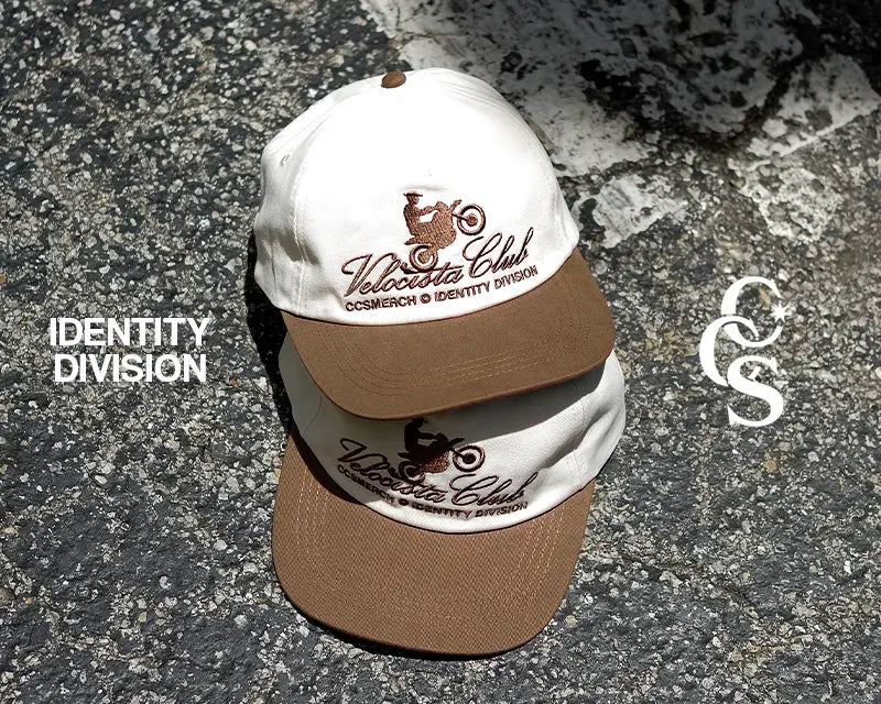 Two Velocista Club caps styled on pavement for Identity Division campaign