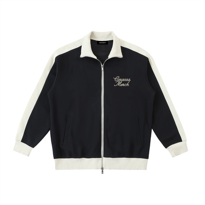 Navy zip up jacket with cream trim and Caracas Merch embroidery front view