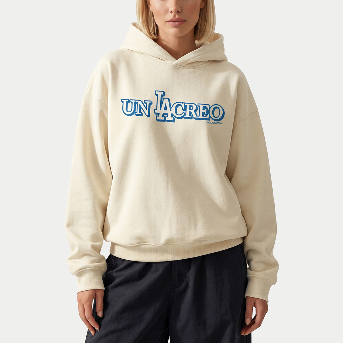 Female model wearing cream Caracas Merch “Un Lacreo” hoodie front view