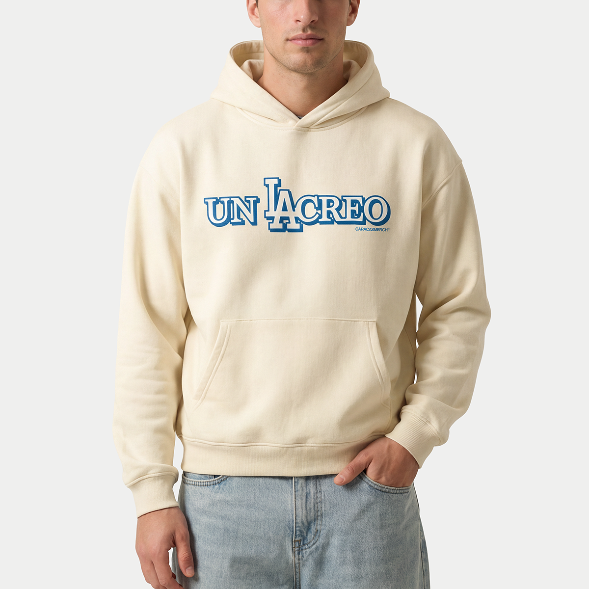 Male model wearing cream Caracas Merch “Un Lacreo” hoodie front view