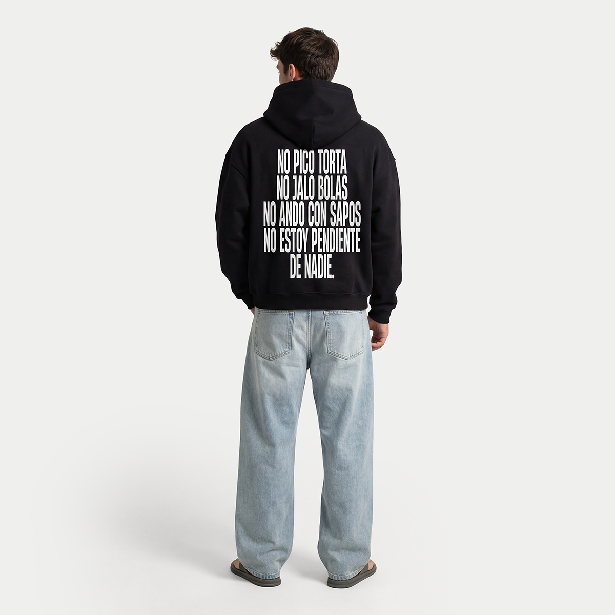 Full body back view of model wearing black Caracas Merch “No pico torta” hoodie