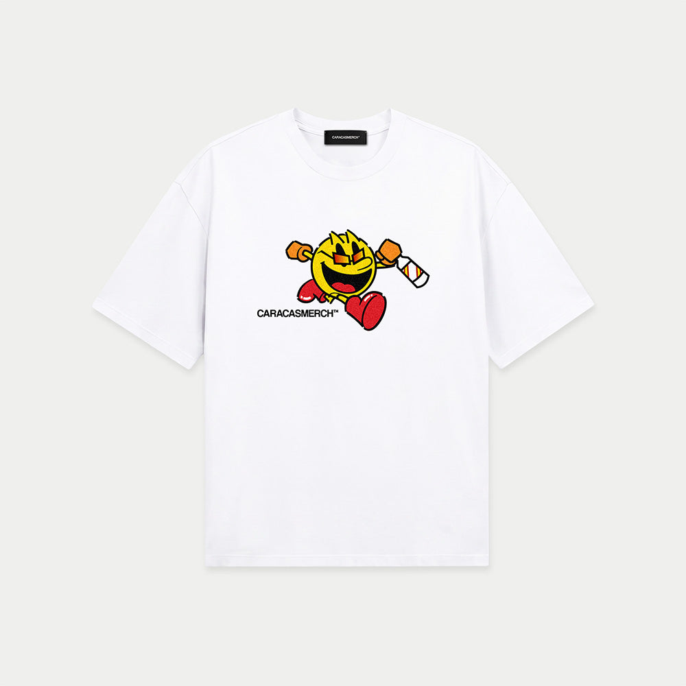 White oversized t-shirt front view with cartoon running character graphic holding a bottle and Caracas Merch logo underneath