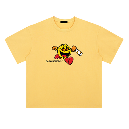 Yellow oversized t-shirt front view with cartoon running character graphic holding a bottle and Caracas Merch logo underneath