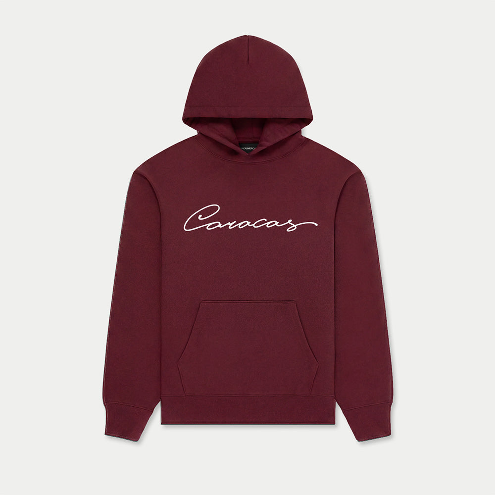 Caracas burgundy hoodie with script logo by Caracas Merch
