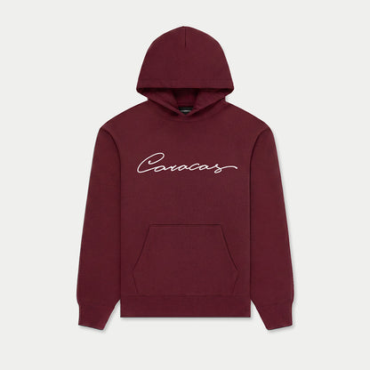 Caracas burgundy hoodie with script logo by Caracas Merch