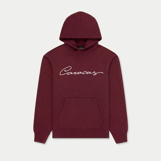 Caracas burgundy hoodie with script logo by Caracas Merch