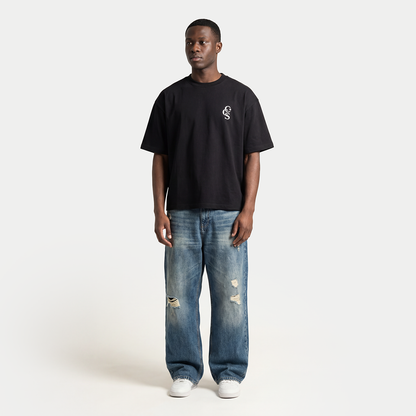 Full body model wearing black CCS t-shirt by Caracas Merch