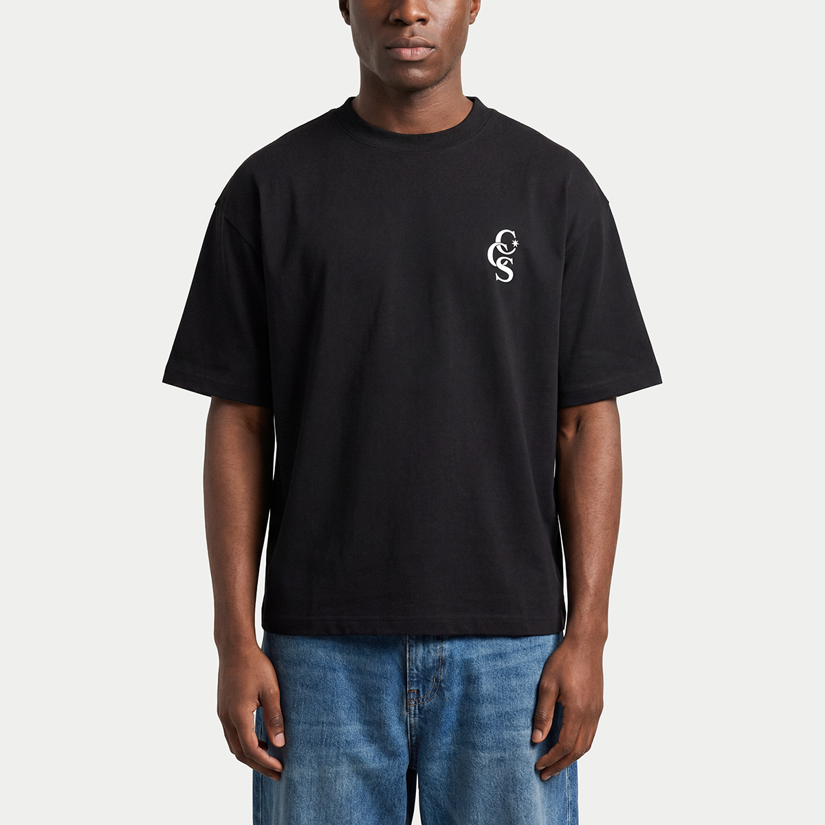 Model wearing black CCS t-shirt by Caracas Merch