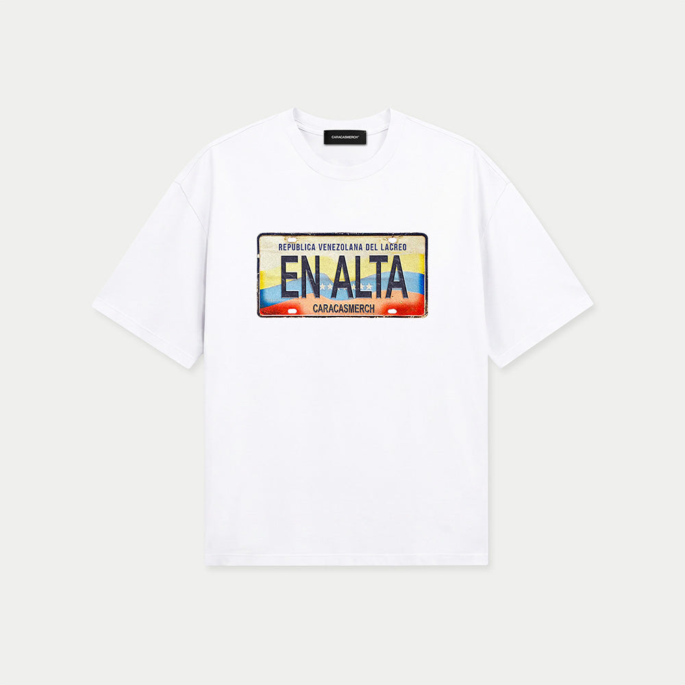 White t-shirt by Caracas Merch featuring En Alta placa de carro graphic inspired by Venezuela