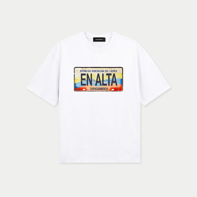 White t-shirt by Caracas Merch featuring En Alta placa de carro graphic inspired by Venezuela