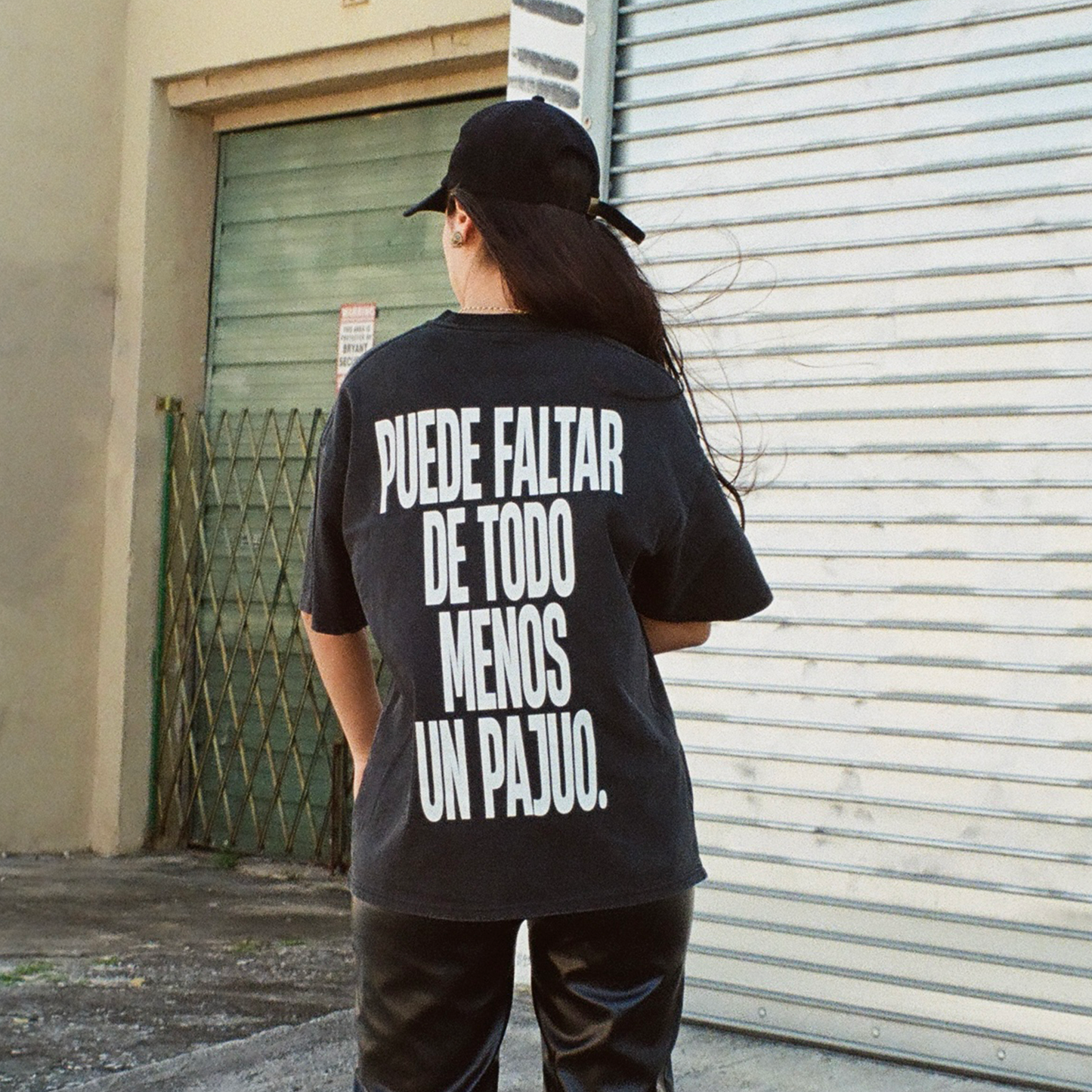 Female model wearing puede faltar de todo menos un pajuo black tee lifestyle shot