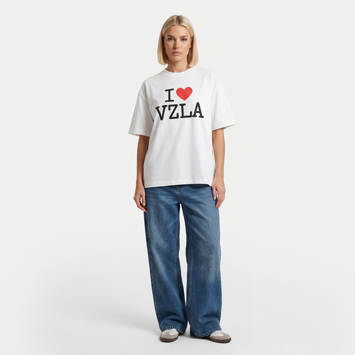 Female model wearing i love venezuela white graphic t-shirt by Caracas Merch