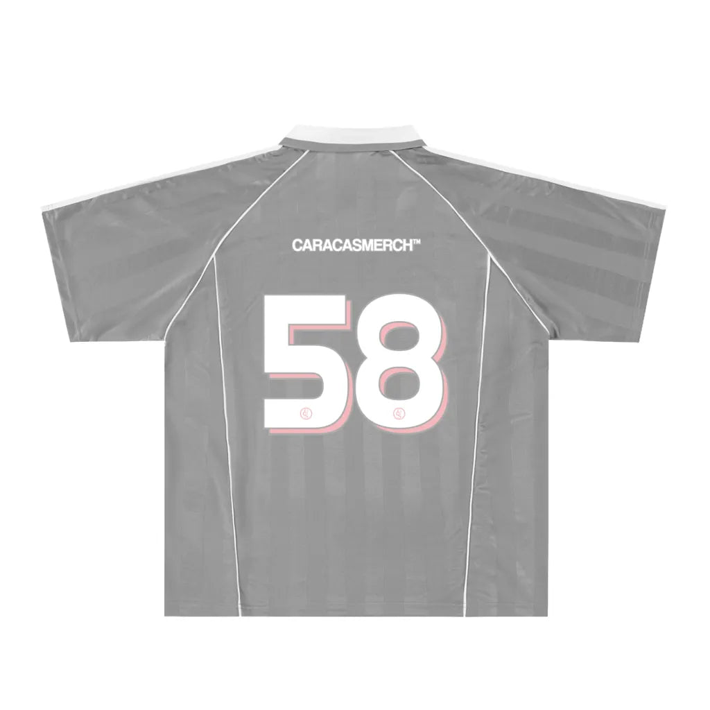 Grey soccer-style jersey back view with “CARACASMERCH” text on upper back and large number 58 in white with red outline – Caracas Merch
