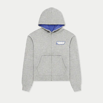 Front view of gray zip-up hoodie by Caracas Merch with blue inner hood lining and DTF logo