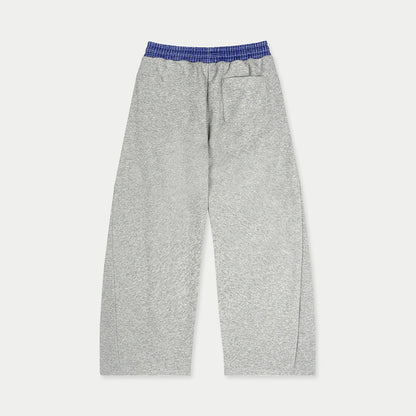 Back view of gray Caracas Merch sweatpants with elastic waistband