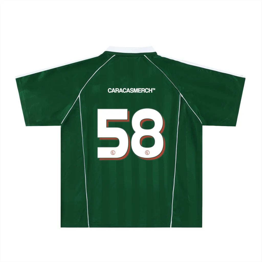 Green soccer-style jersey back view with “CARACASMERCH” text on upper back and large number 58 in white with red outline – Caracas Merch