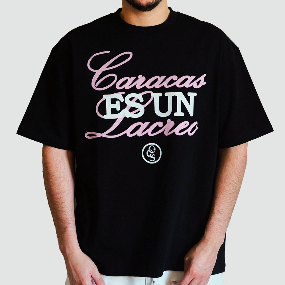 Male model wearing caracas es un lacreo black graphic t-shirt