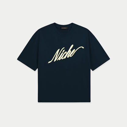 Navy blue oversized boxy t-shirt front view with elegant “Niche” script logo in white centered on the chest – Caracas Merch