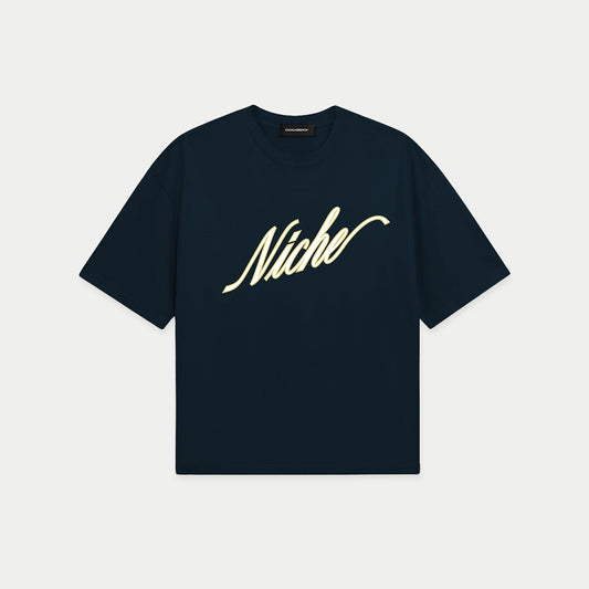 Navy blue oversized boxy t-shirt front view with elegant “Niche” script logo in white centered on the chest – Caracas Merch