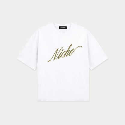 White oversized boxy t-shirt front view with elegant “Niche” script logo in gold centered on the chest – Caracas Merch