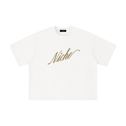 White oversized boxy t-shirt front view with elegant “Niche” script logo in gold centered on the chest – Caracas Merch