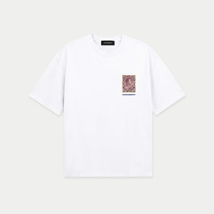 White oversized t-shirt front view with small vintage-style postage stamp graphic on chest featuring a classic portrait – Caracas Merch