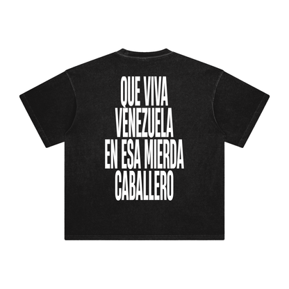 Black oversized t-shirt back view with bold black text graphic reading “Que viva Venezuela en esa mierda caballero” – Caracas Merch